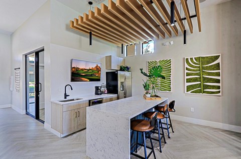 a kitchen with a marble counter top and a bar with stools